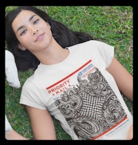a woman laying on the grass wearing a t - shirt